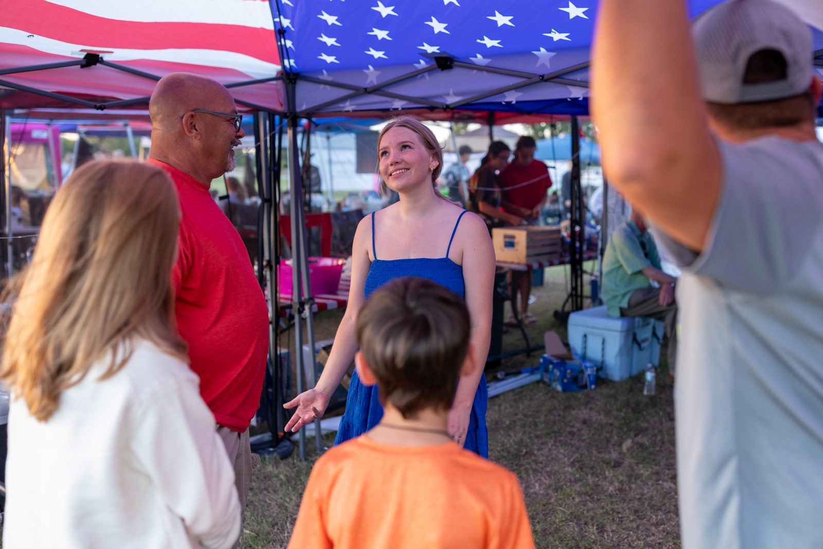 Guests visiting under the tents at the celebration