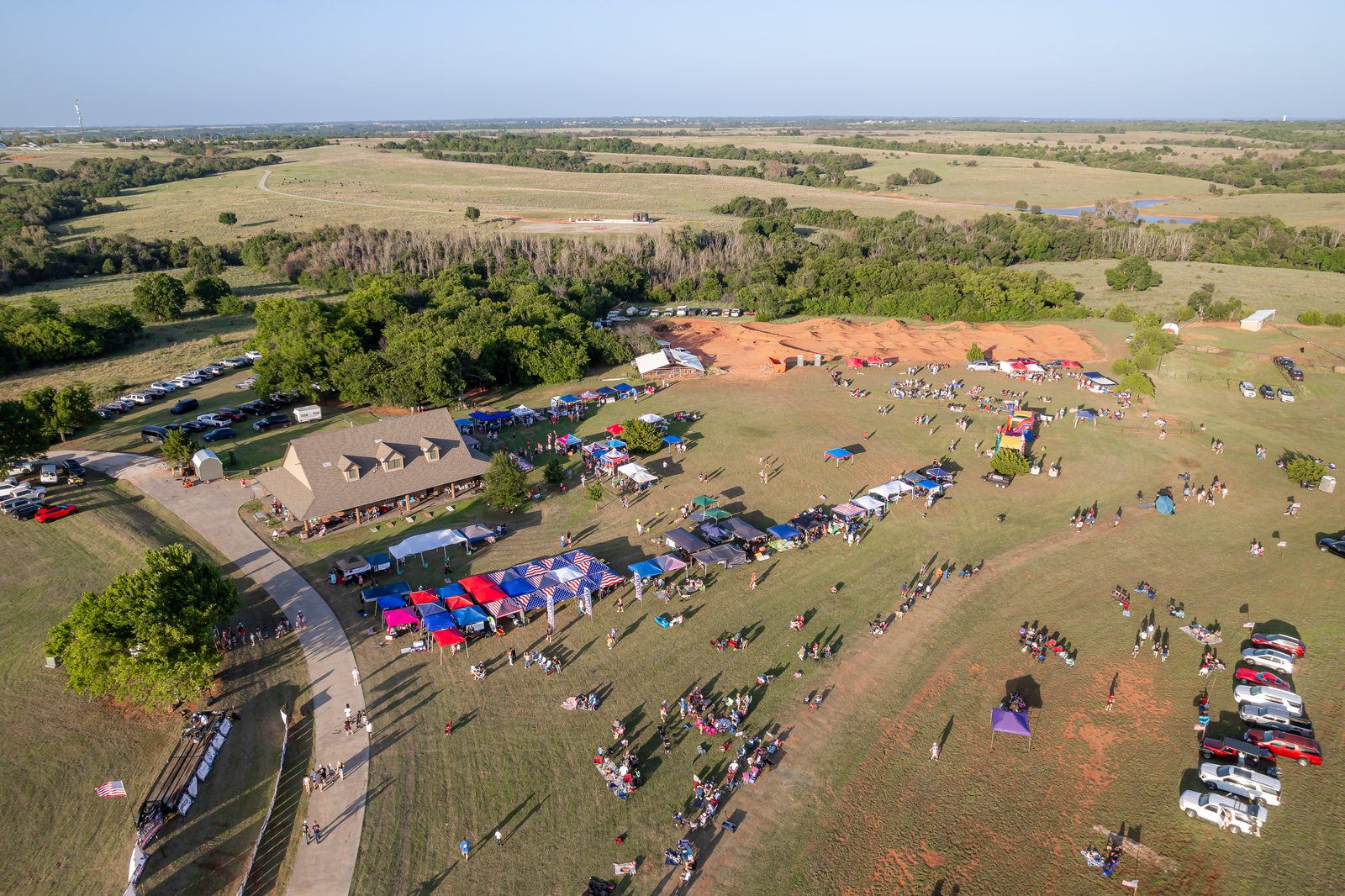 Aerial view of tents and families at LIME Realty's Independence Day Celebration