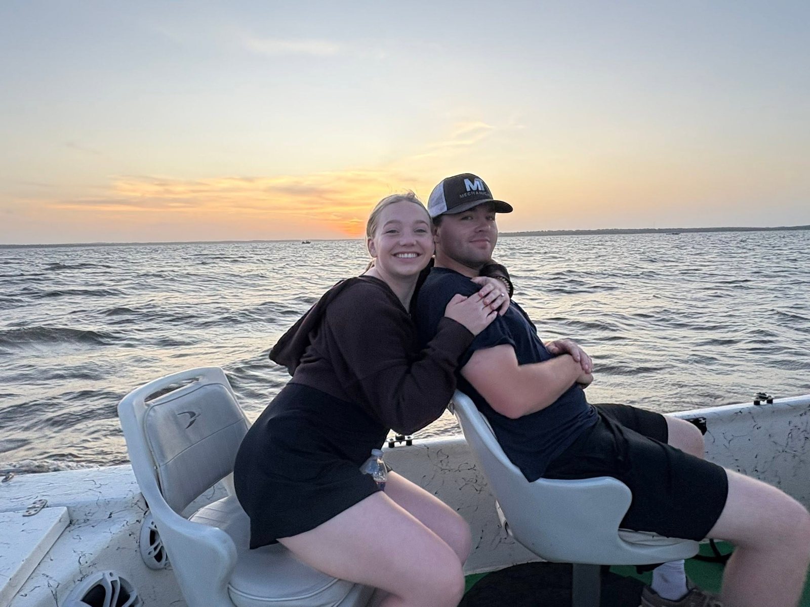 Cheyanne and Travis on a boat at sunset