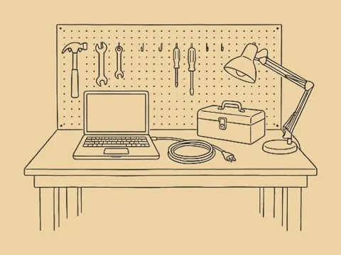 An ink drawing of a workbench with an open laptop, a toolbox and a lamp.