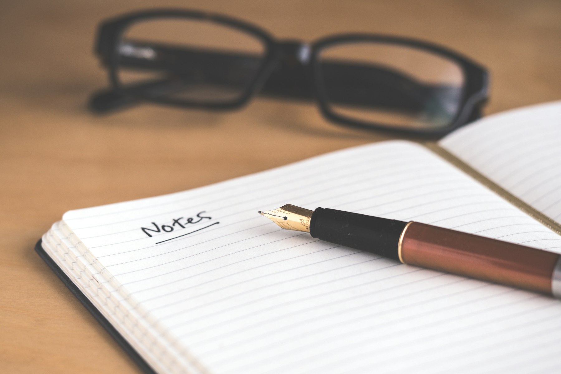 A notebook and pen on a desk