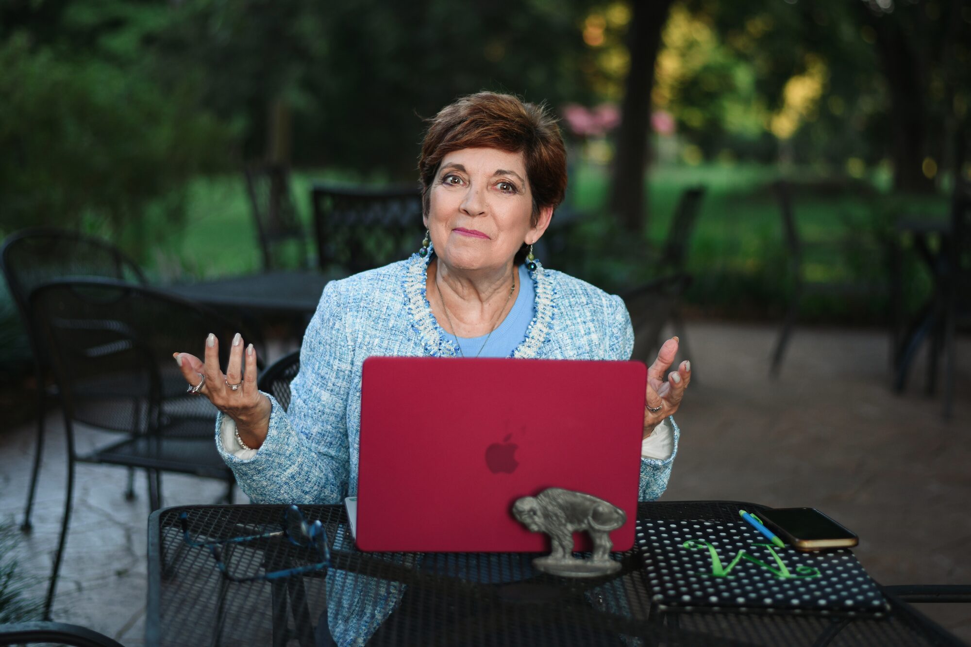 MaryAnn Molloy at her laptop with a playful, puzzled shrug