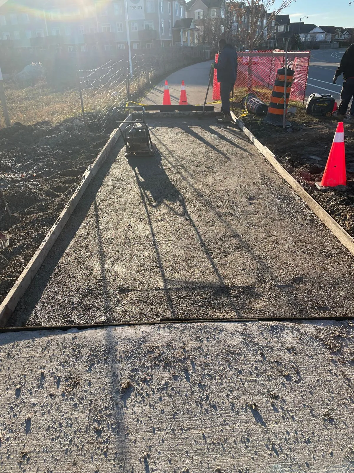 Compacted base before sidewalk concrete pour in the GTA