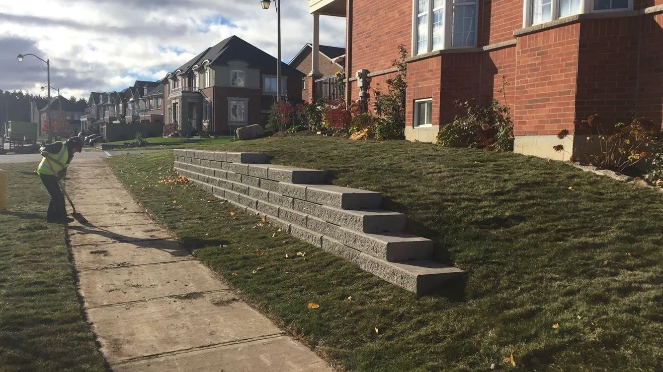 Heavy armor stone retaining wall along a commercial grade in the GTA