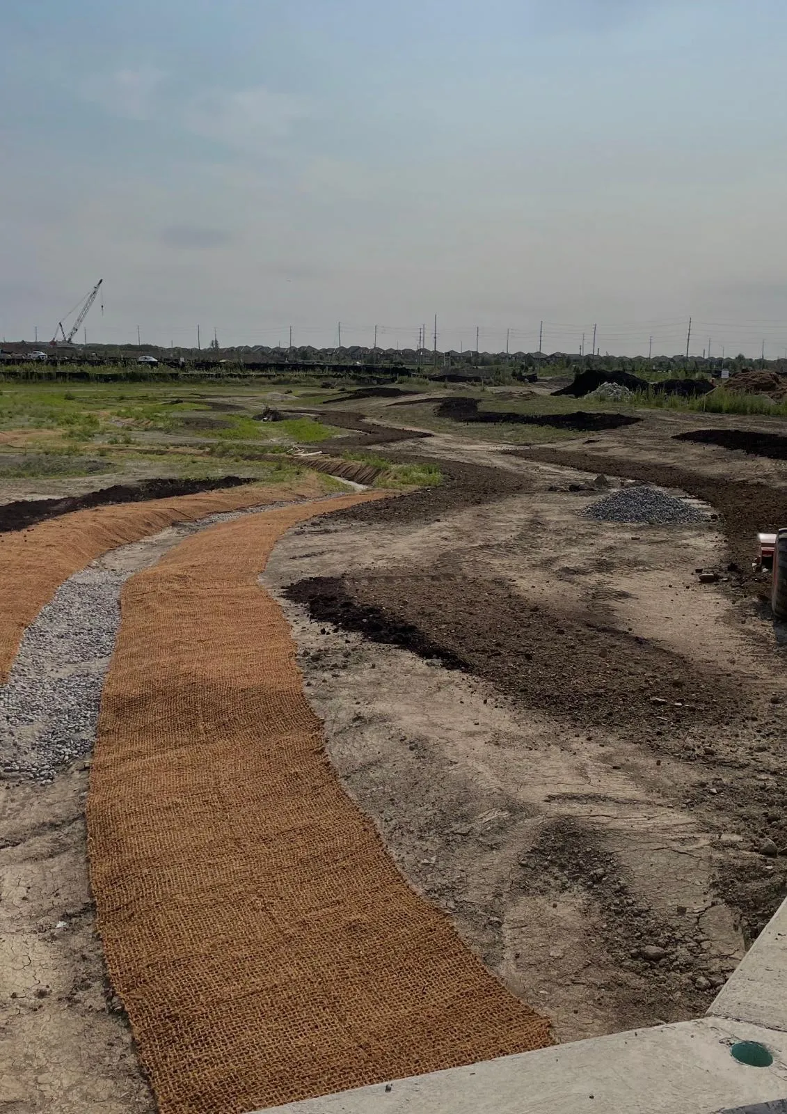 Erosion control blanket and silt fencing protecting a graded GTA slope
