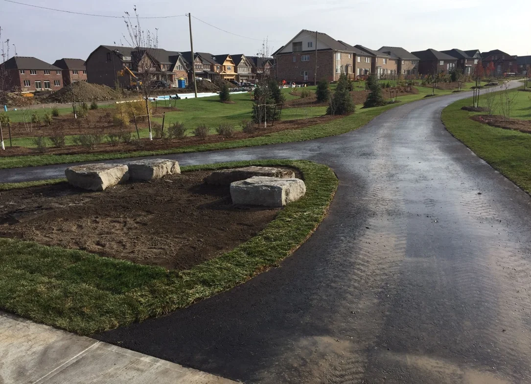 Newly built gravel pathway winding through a GTA green space