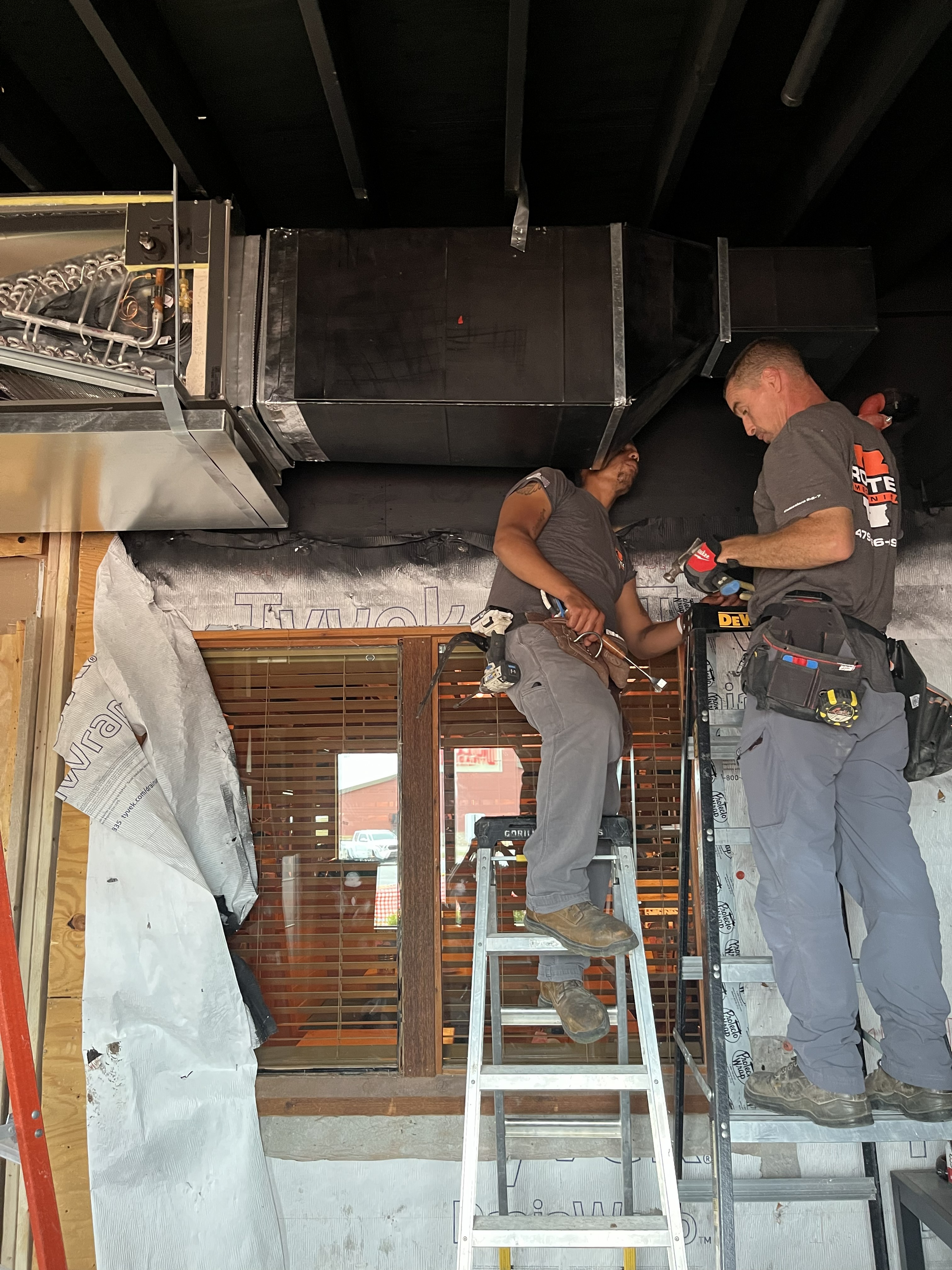AC repair technician working on residential unit in Centerton Arkansas