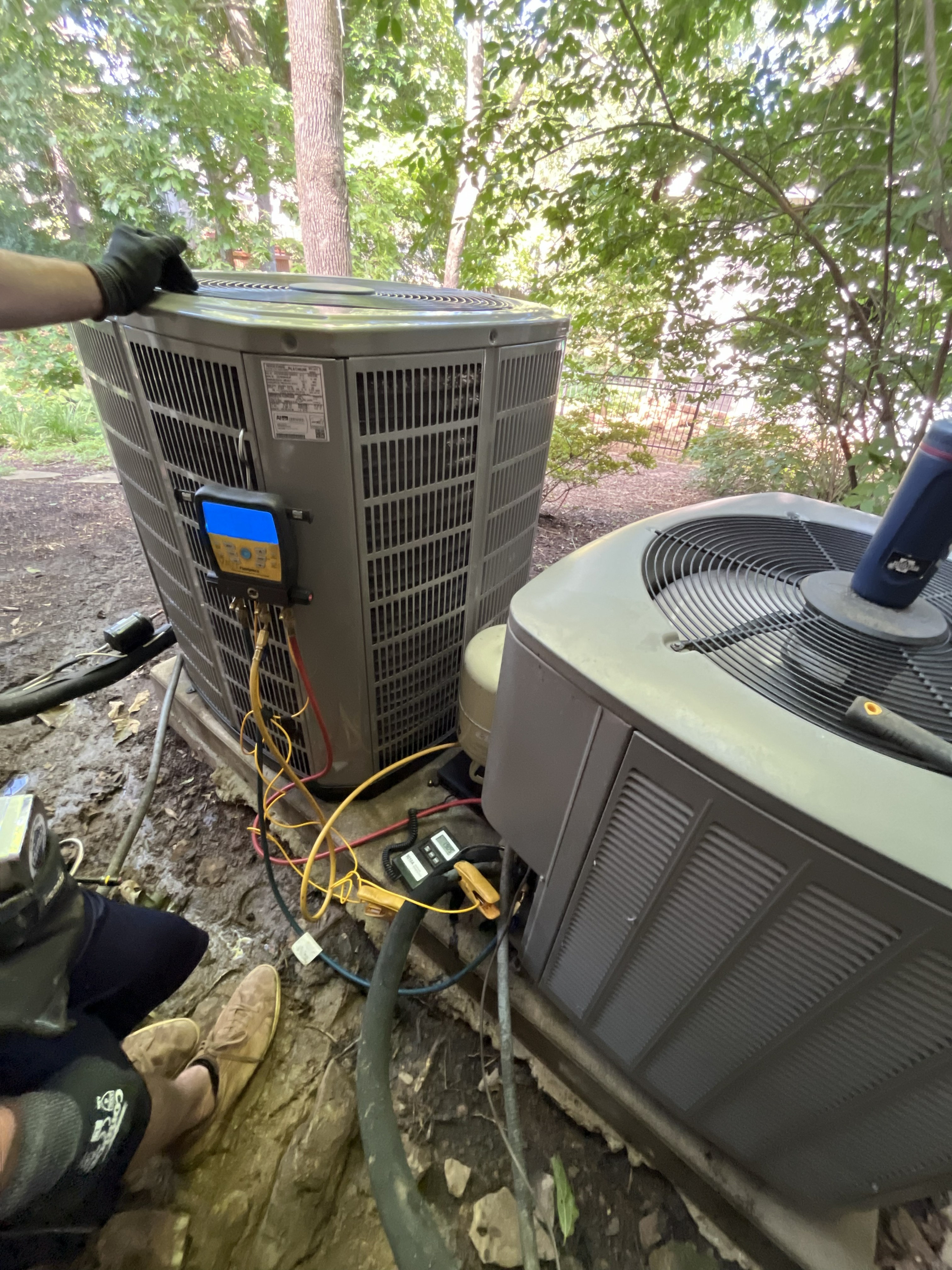 HVAC technician diagnosing AC system in Rogers Arkansas