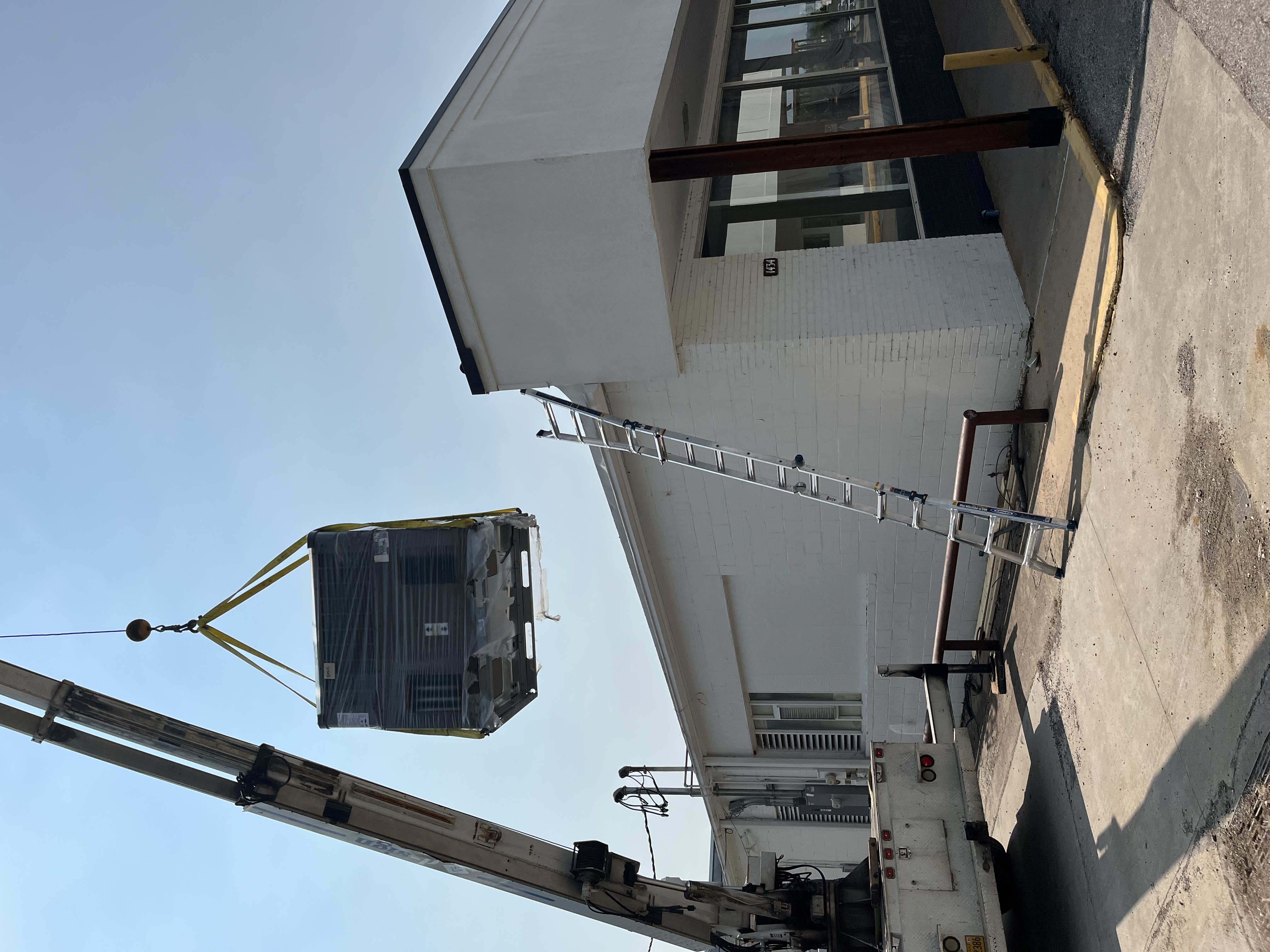 Rooftop HVAC maintenance technician working in Rogers Arkansas