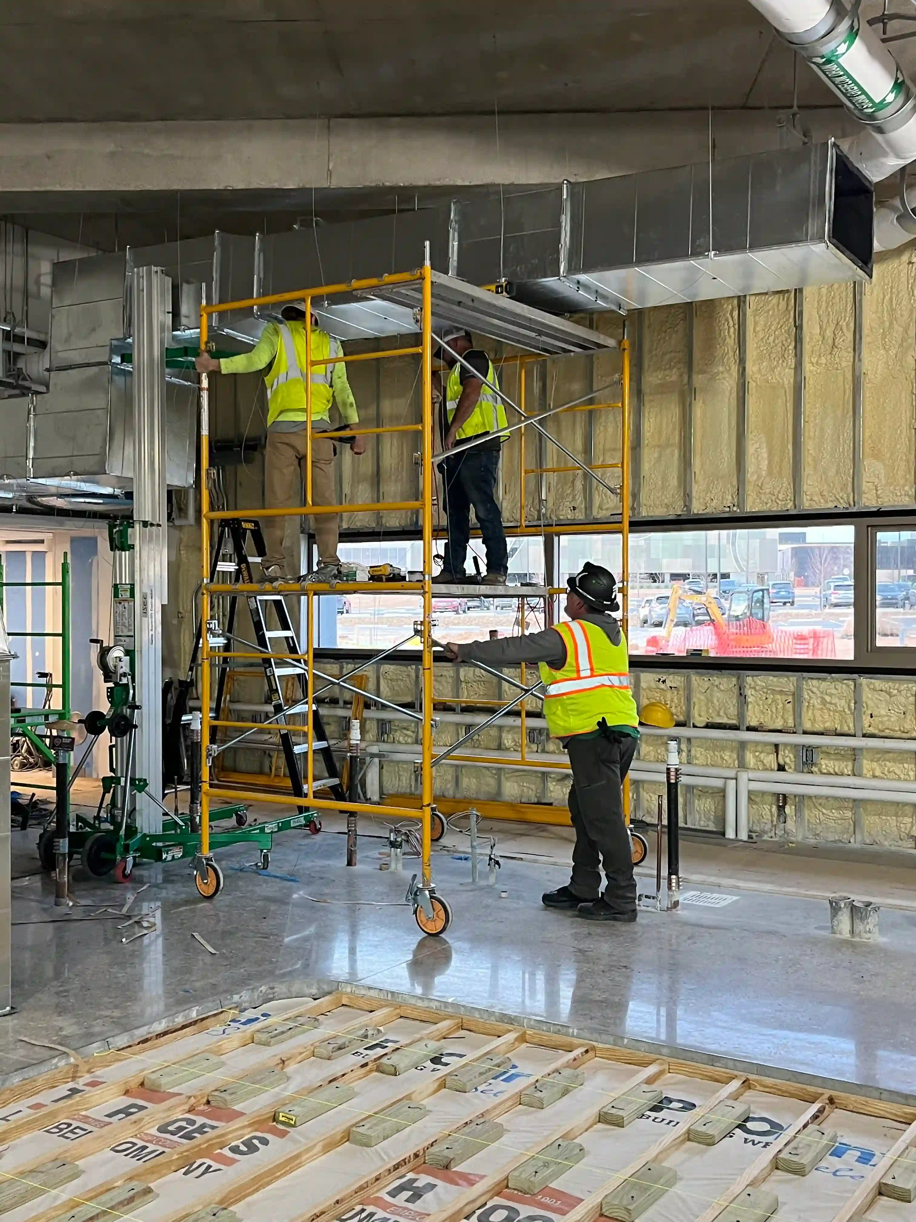 Commercial HVAC installation using scissor lift in Rogers Arkansas