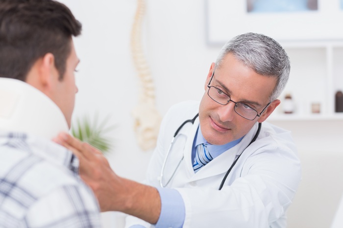 neck strap on neck by chiropractor