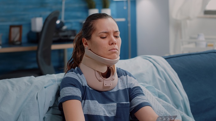 women in a neck brace after a car accident whiplash pain