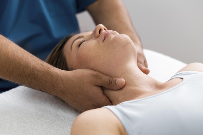 chiropractor adjusting a patient neck after an auto accident injury