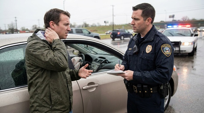 injured man talking to police after car accident