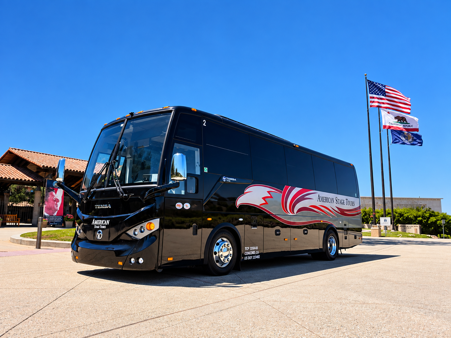 An American Stage Tours coach parked beside a row of flags.