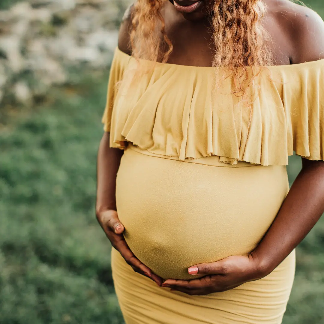 Parent holding baby while reviewing finances