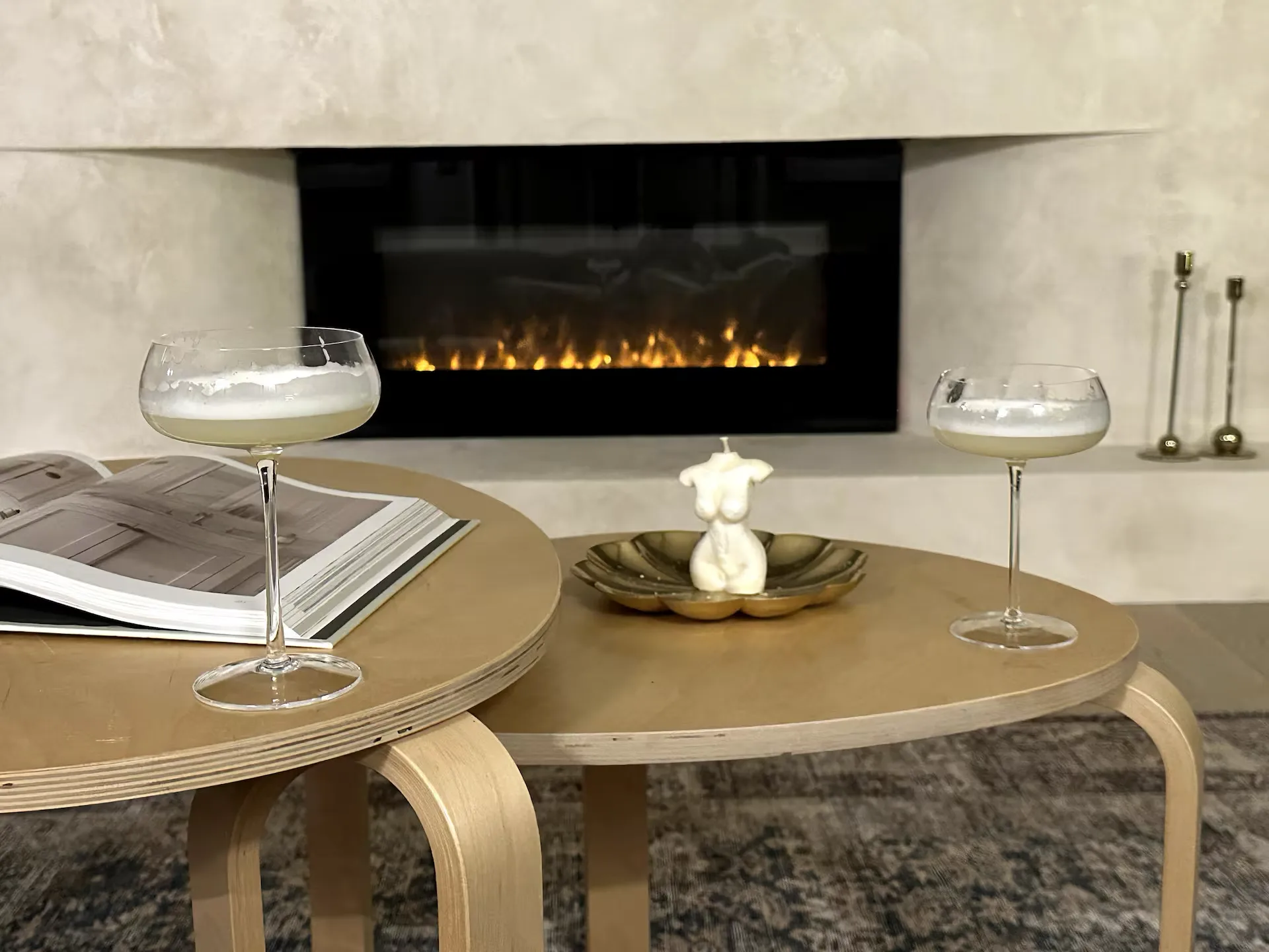 Modern fireplace lounge setup with cocktail glasses and minimalist decor at The White House
