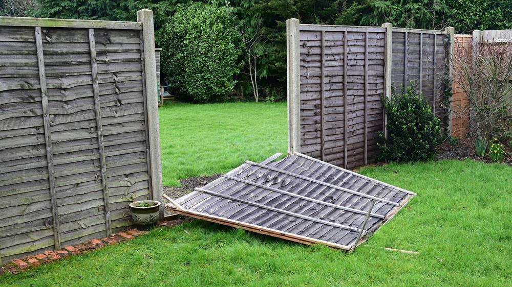 Wood fence section braced during repair