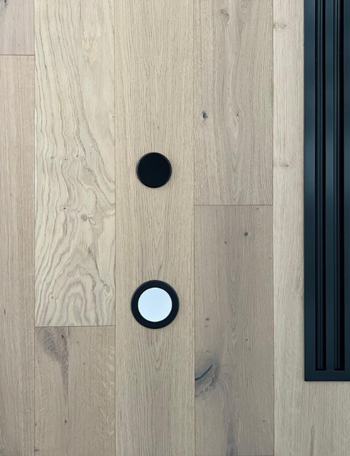 Close-up of black fire sprinkler installed on a wood ceiling