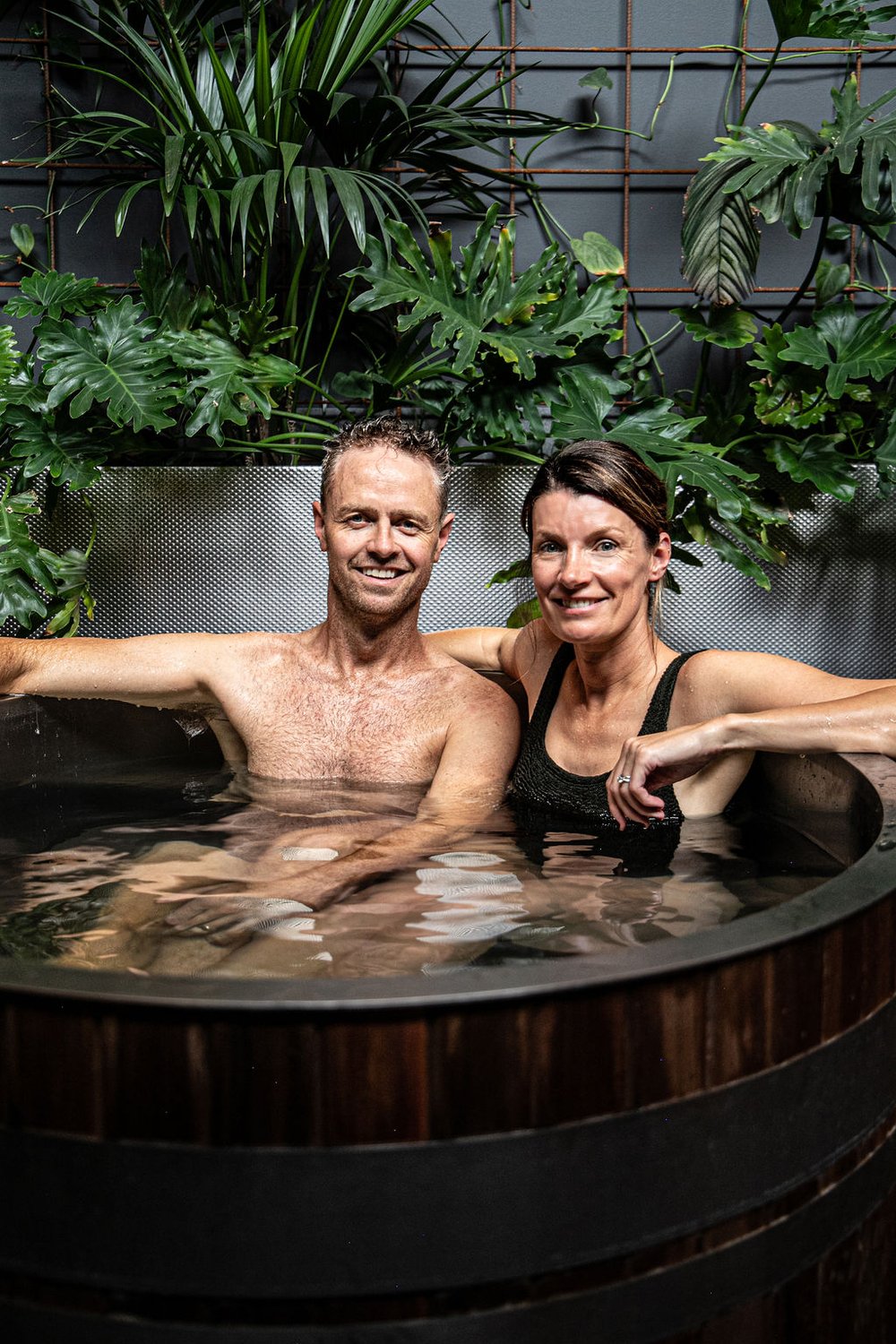A couple relaxing together in the plunge at re.nu