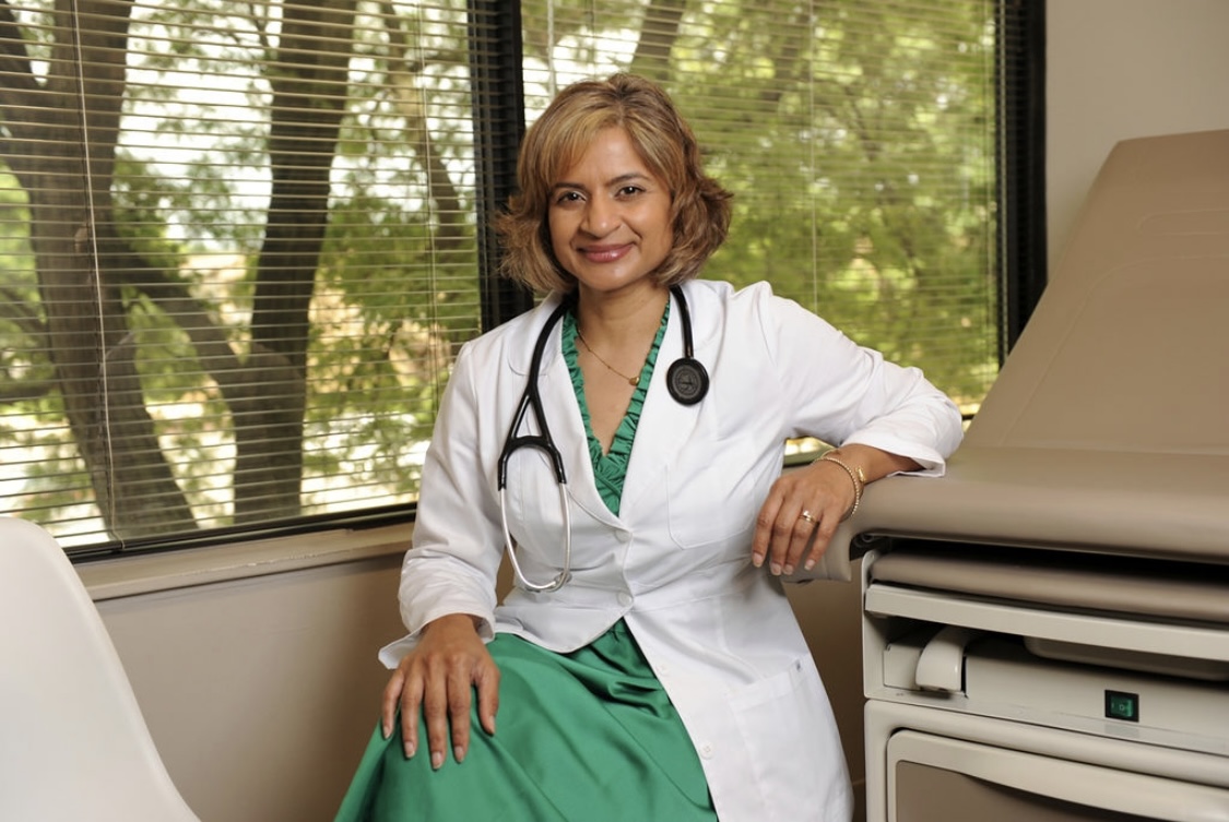 Lynn Masih, CRNP, in a white coat with stethoscope at Burtonsville Family Health.