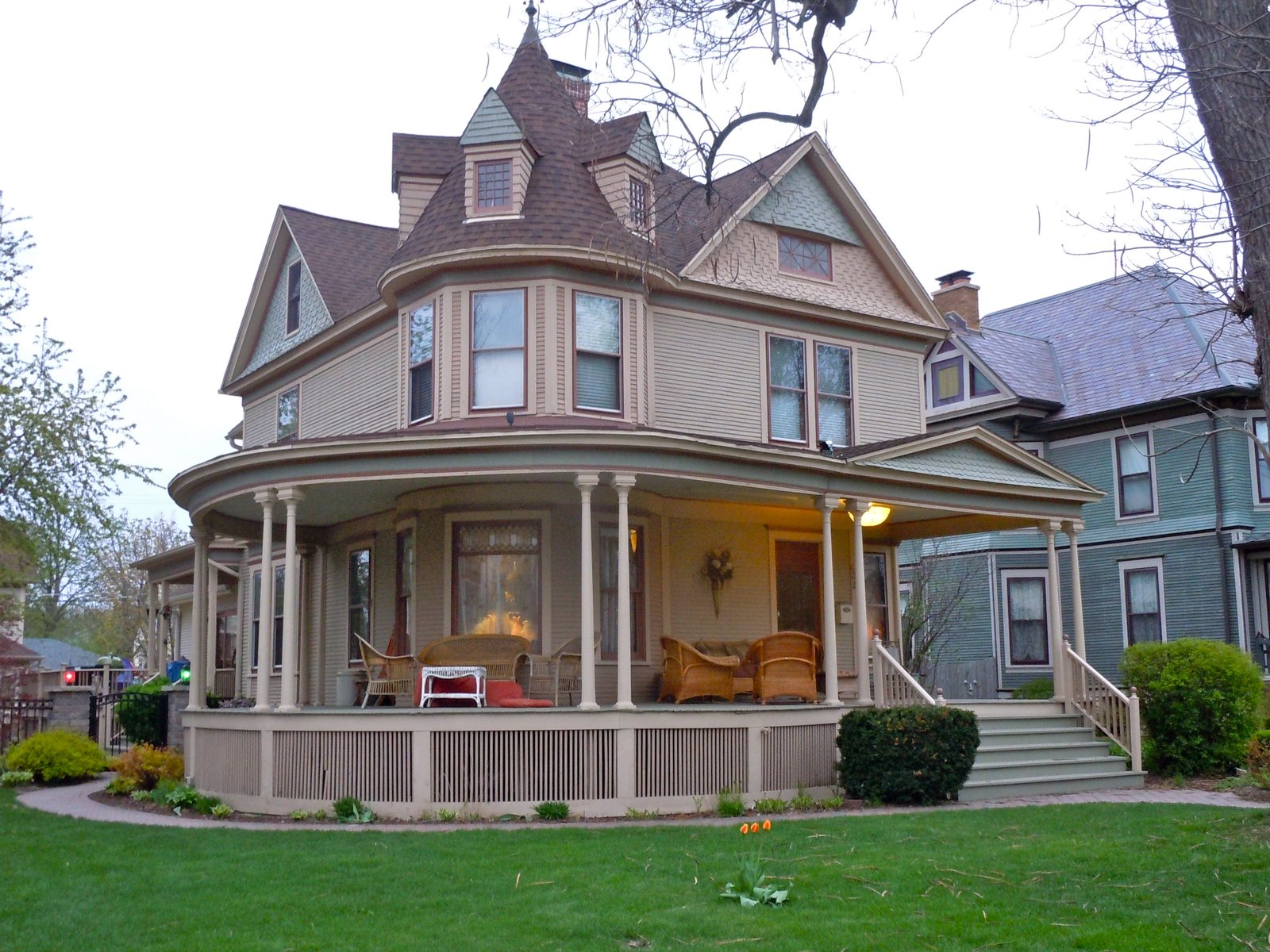 Two-story house with a wide wraparound front porch in the Upper Bluff Historic District of Joliet, Illinois