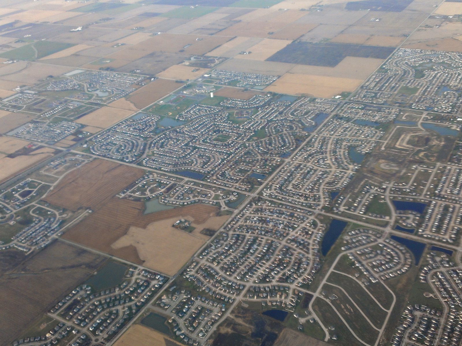 An aerial view of rows of homes in the Fields and Riverbrook Estates subdivisions in Plainfield, Illinois