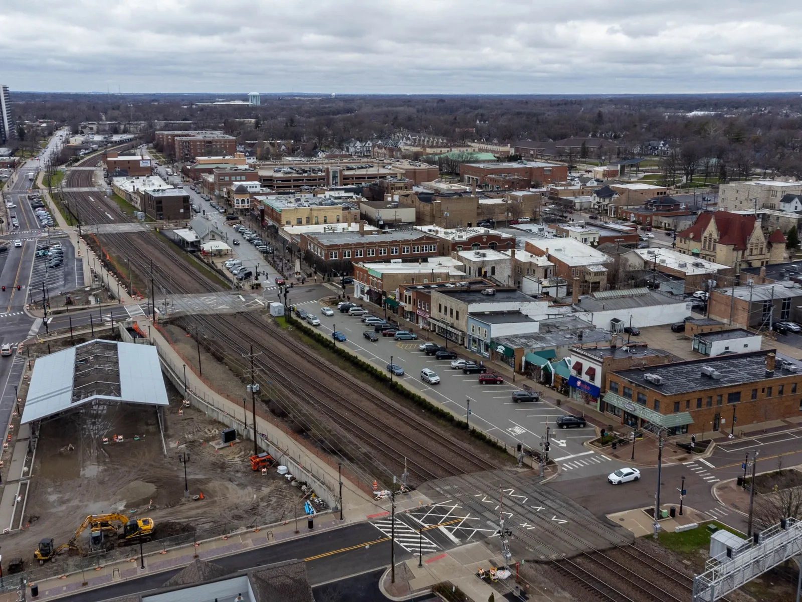 Aerial view of downtown Wheaton, Illinois, with the Metra rail line and the city skyline