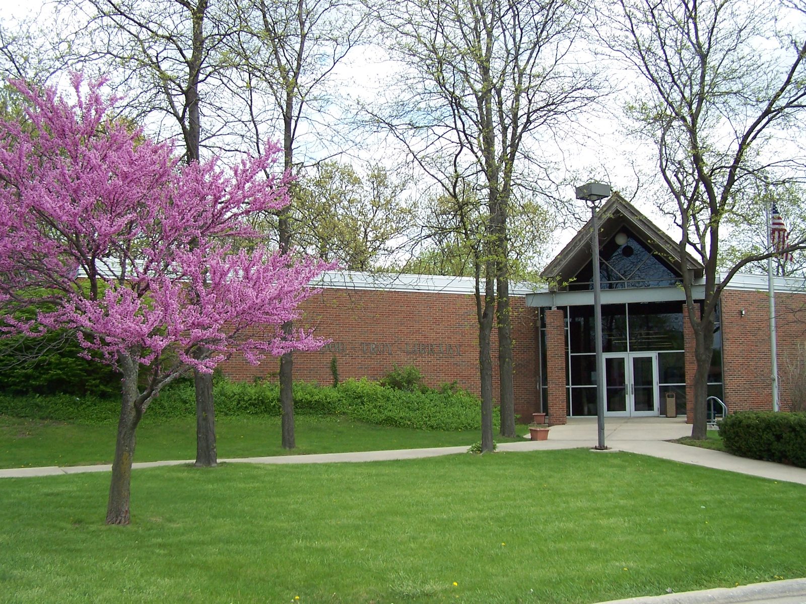 The Shorewood-Troy Public Library in Shorewood, Illinois, with a redbud tree in bloom