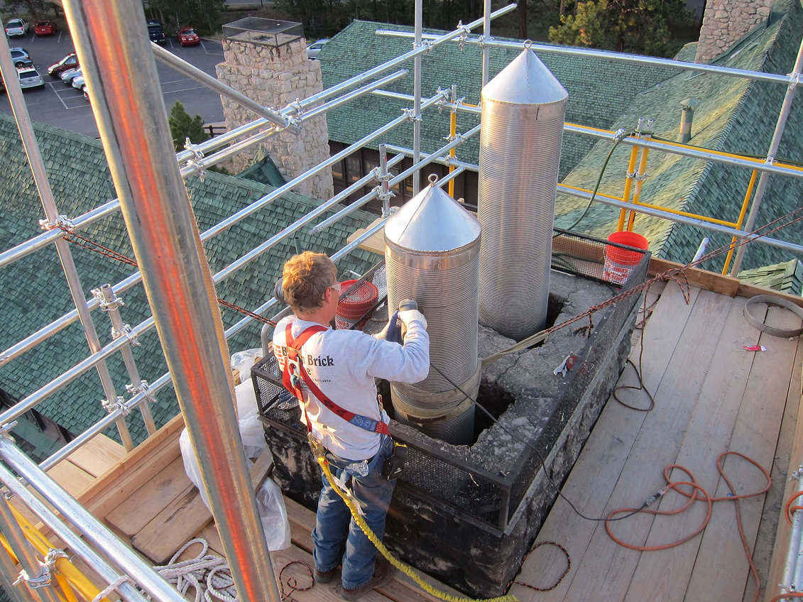 Brick chimney replacement matching home architecture
