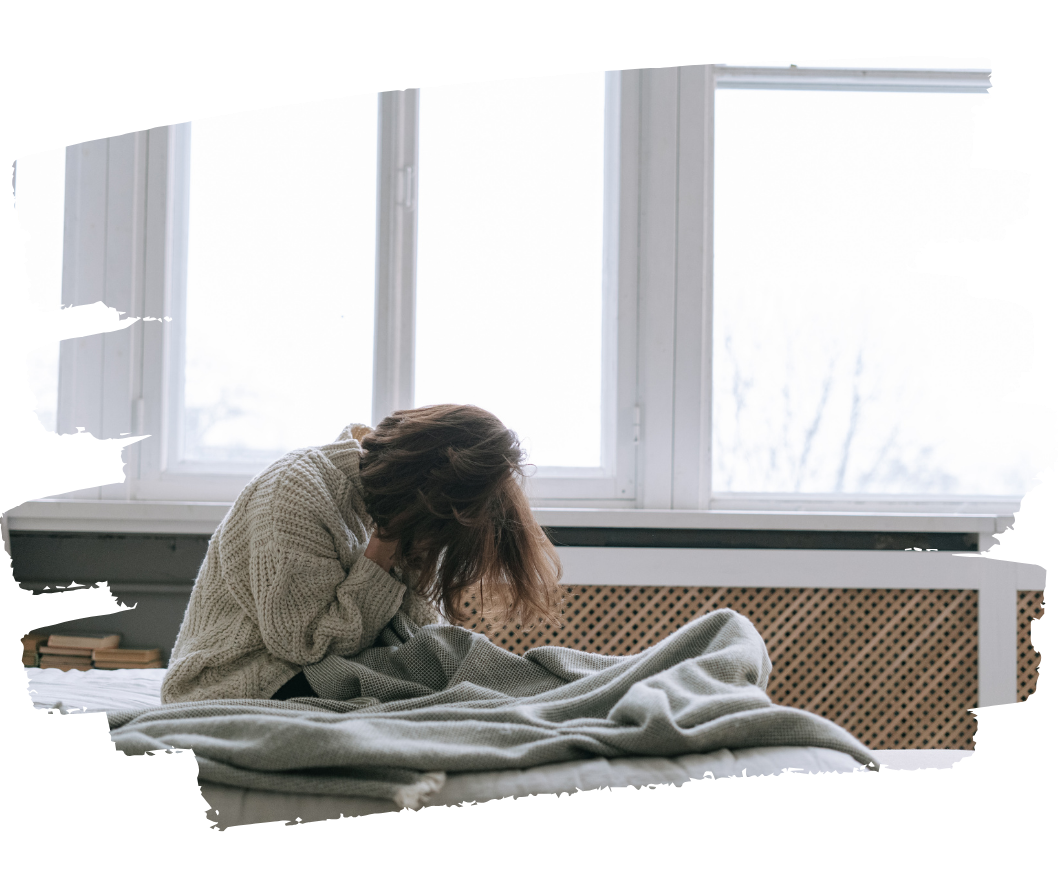 Woman sitting on bed feeling overwhelmed and emotionally distressed in a softly lit bedroom Woman sitting on bed feeling overwhelmed and emotionally distressed in a softly lit bedroom