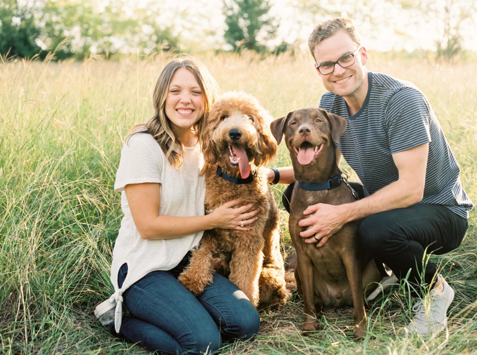 Family with 2 dogs in a field