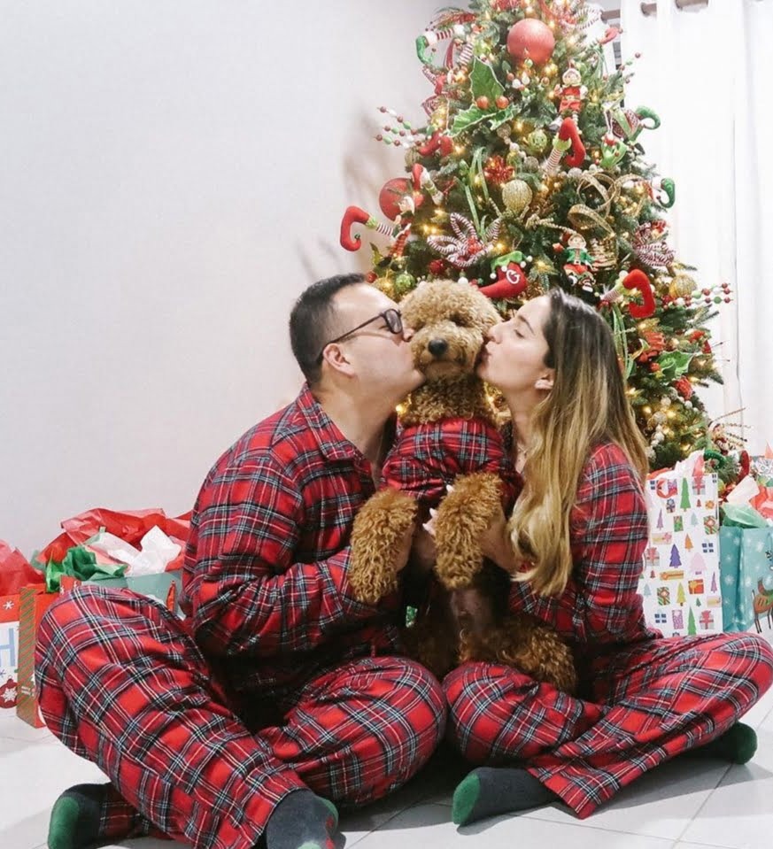 A Couple Kissing their new Dog