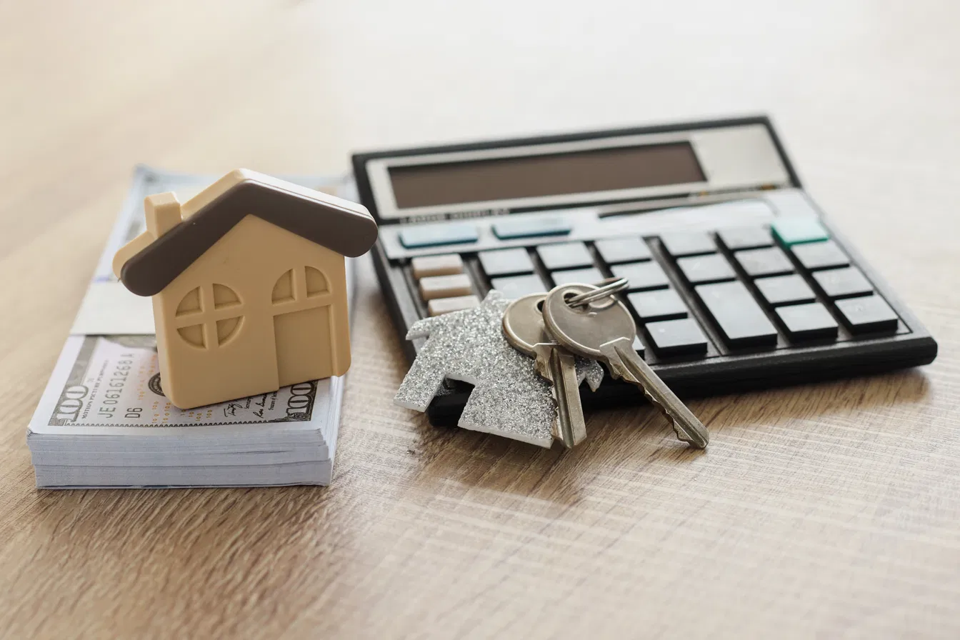 Home sale — keys, cash, and calculator