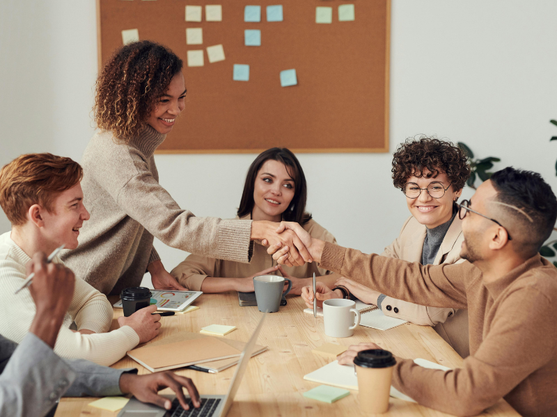 A group of professionals in a meeting, collaboratively working on strategies to protect and maintain brand messaging across every business touchpoint.
