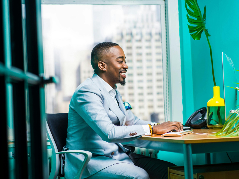 A professional man in an office setting working at his desk, reducing repetitive tasks and saving time with automated workflows.