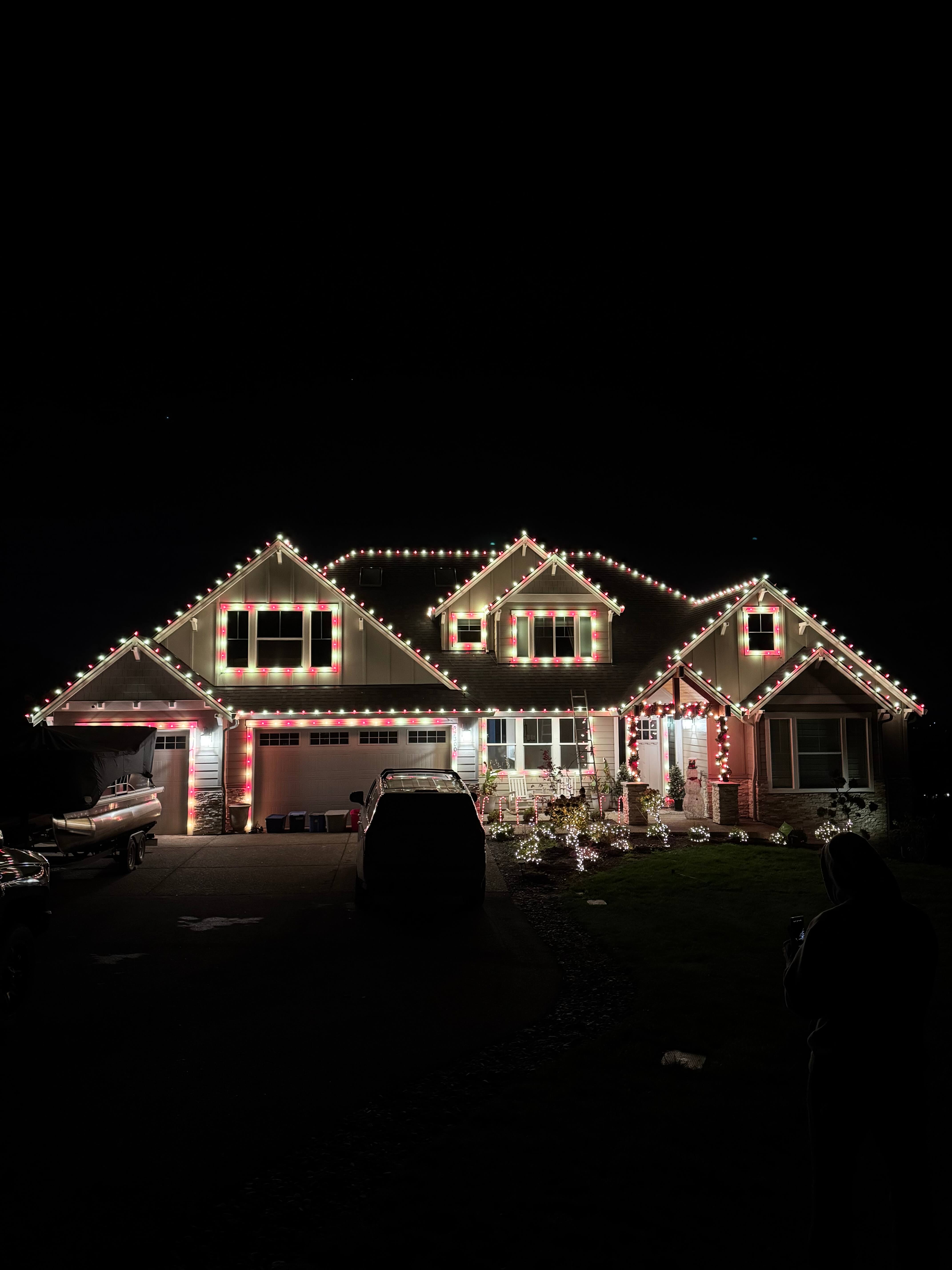 Candy cane red and white Christmas light installation on Oregon home