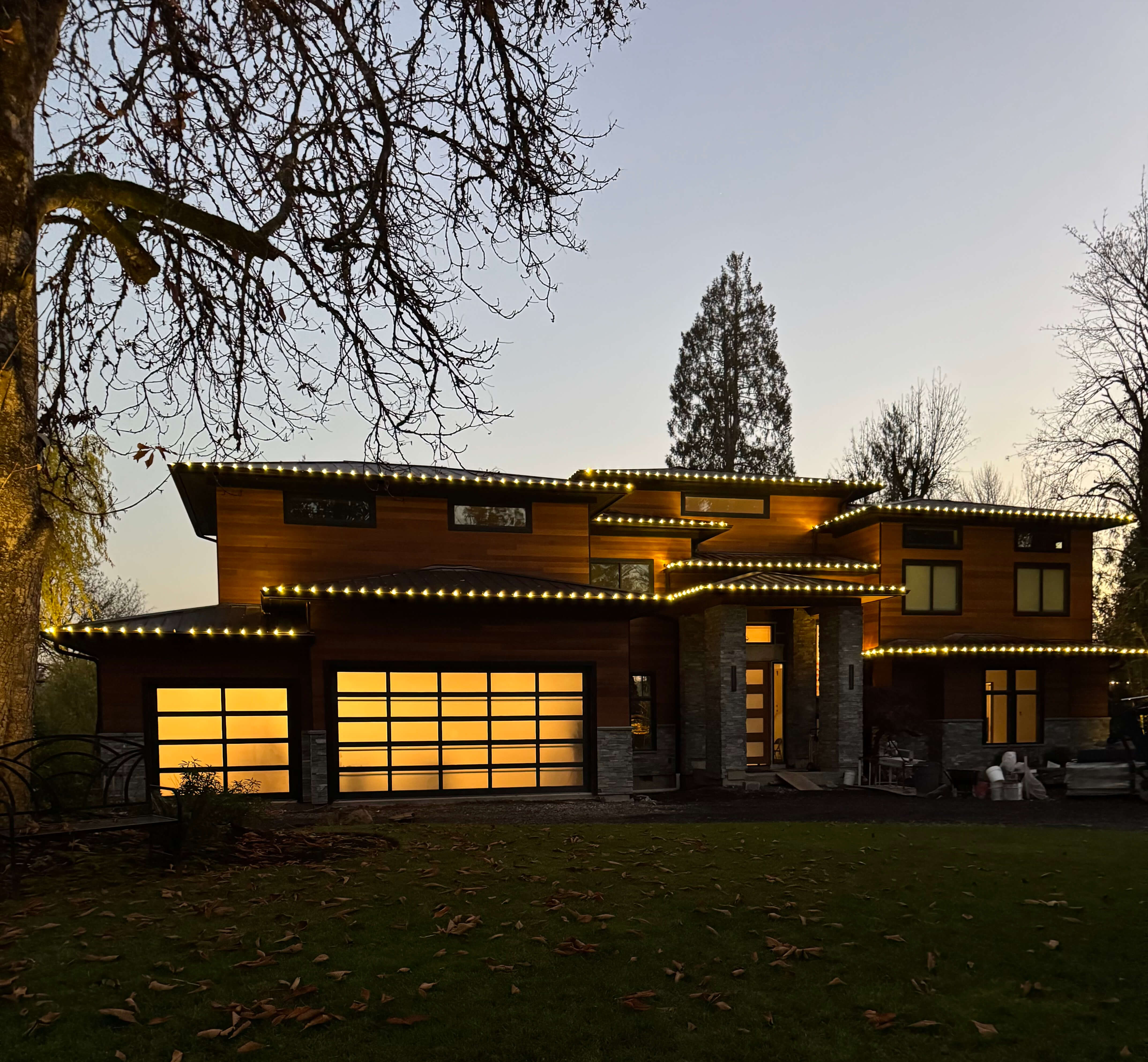 Warm white professional holiday lighting on residential roofline in Oregon
