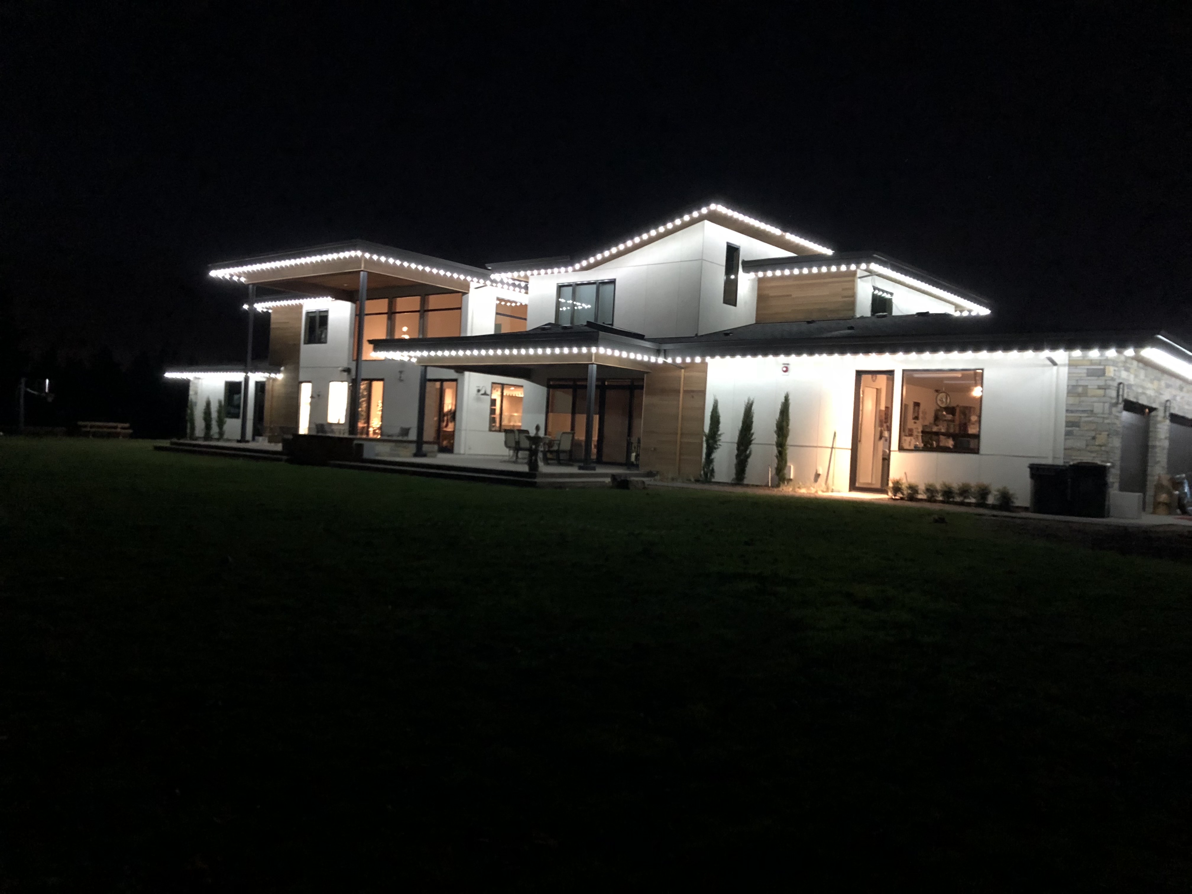 Christmas light installation on a Beaverton, Oregon home lit up at dusk