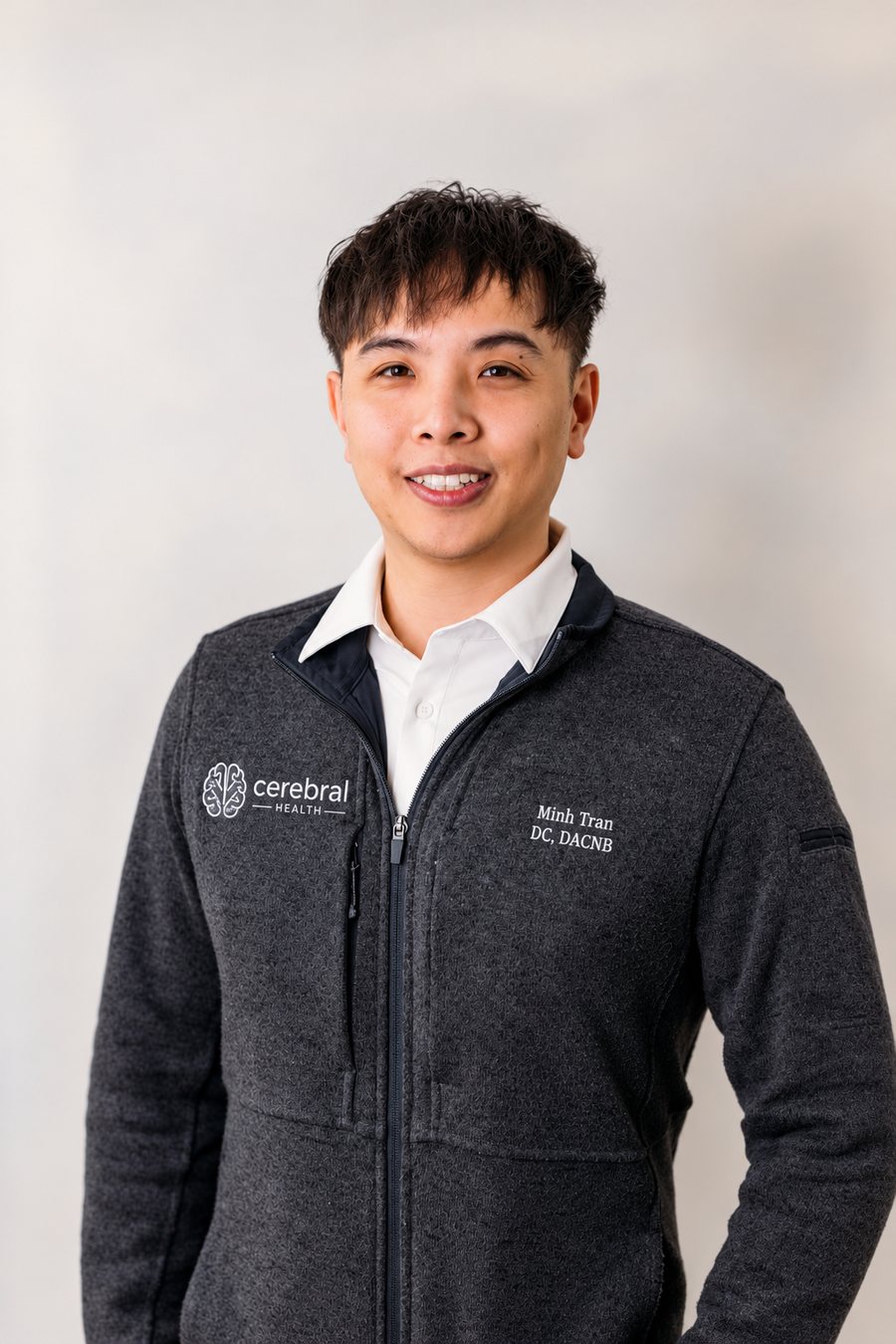 Portrait of Dr. Minh Tran in a Cerebral Health jacket