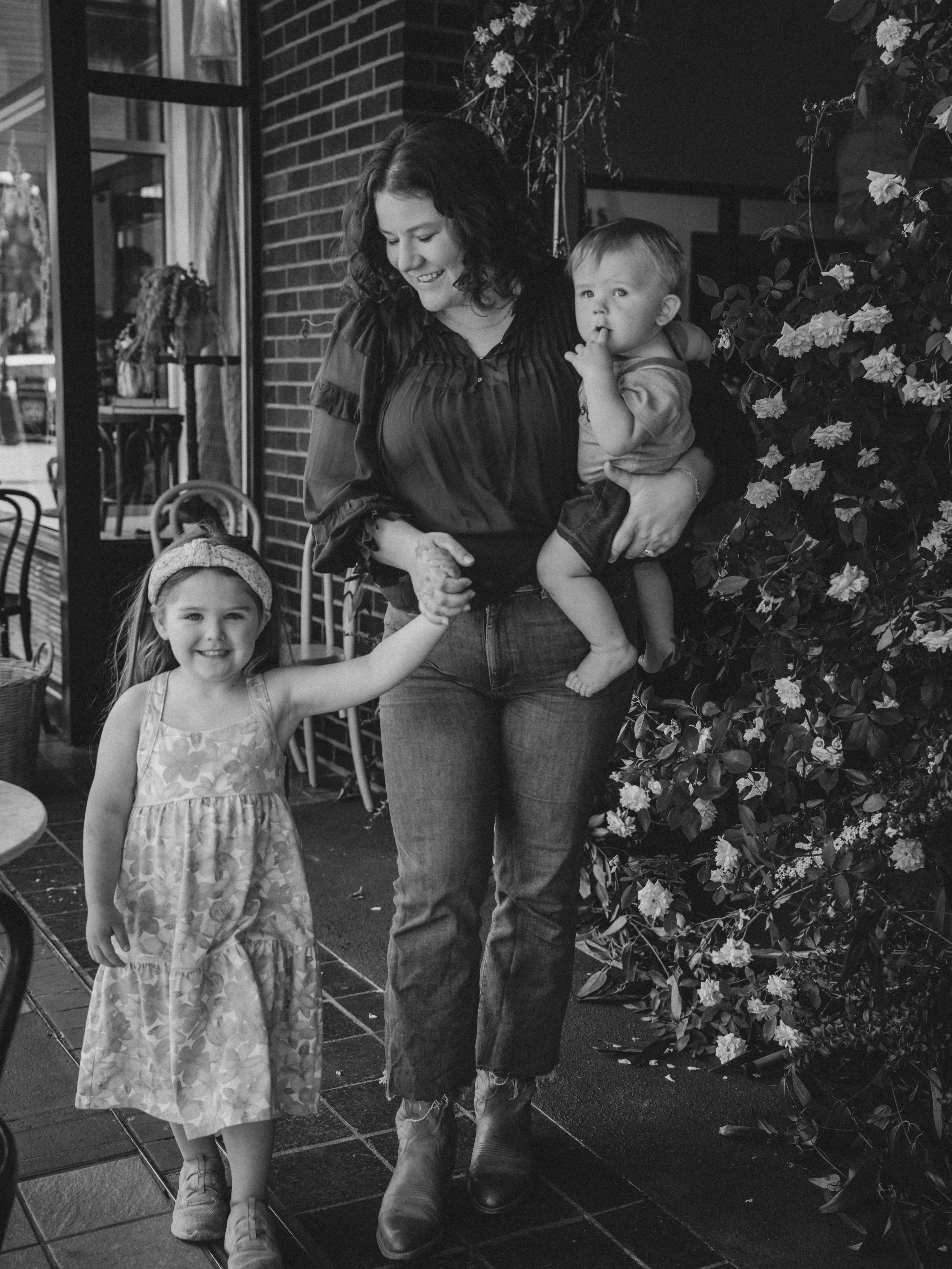 Kelsie walking with her kids, black and white
