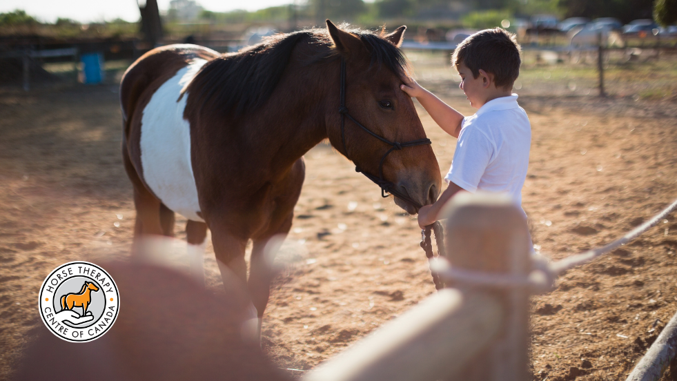 Child holding a horse as part of aba therapy session