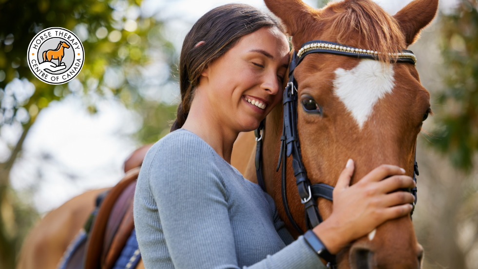 Woman feeling comfortable with a horse in equine therapy certification session