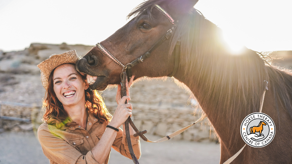 Therapist smiling with a horse in equine therapy certification training