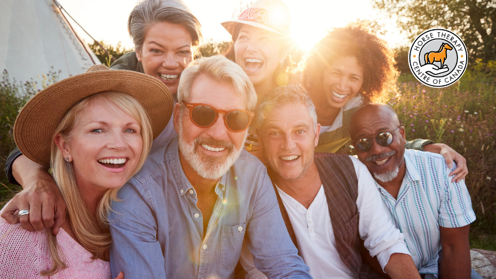 Group of people smiling together showing healing connections in a supportive environment