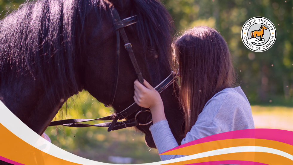 Hand gently touching a horse in equine assisted psychotherapy session