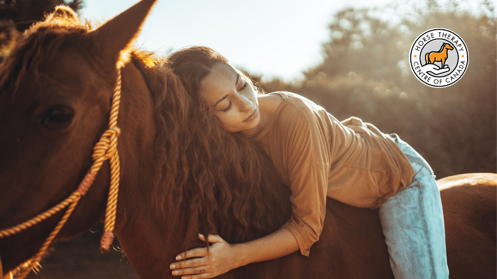 Hand gently touching a horse in equine assisted psychotherapy session