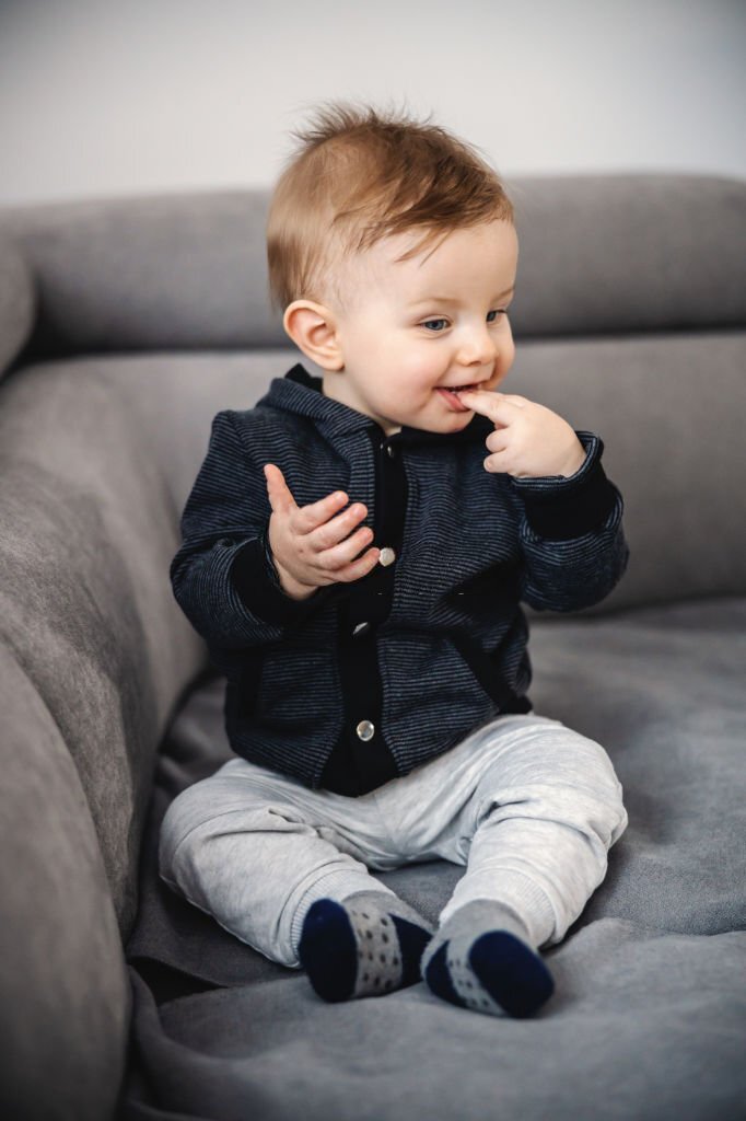 A toddler sitting on a sofa
