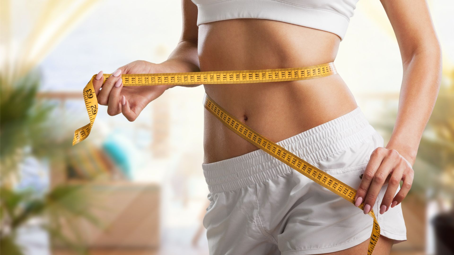 Woman measuring her waist - medical weight loss results
