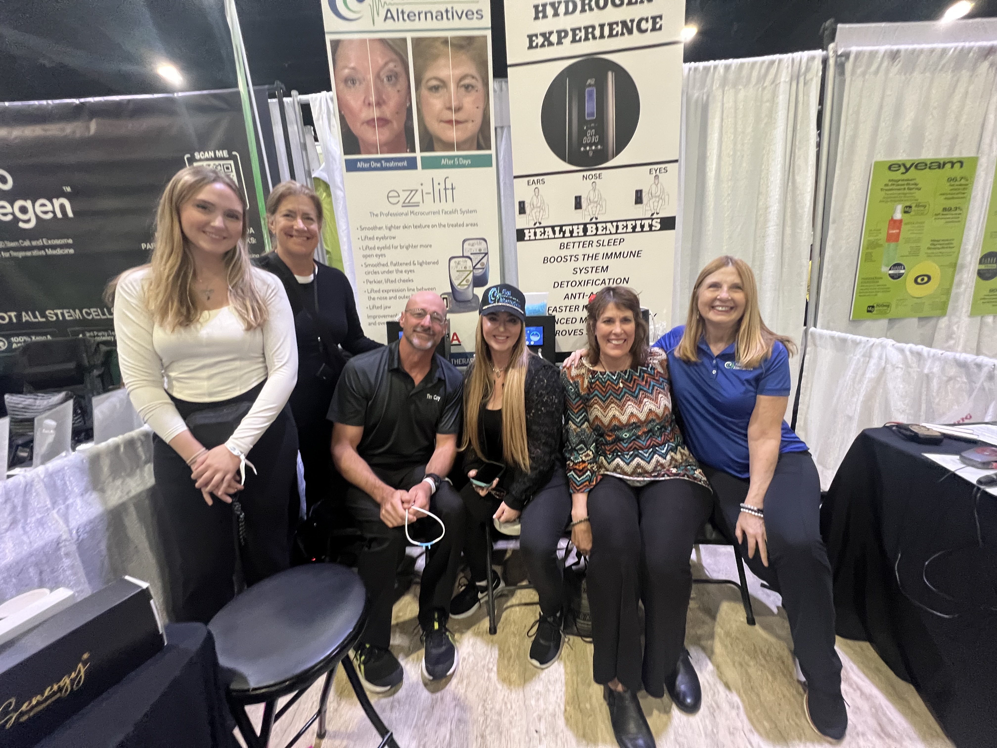 First Alternatives team demonstrating wellness technology at a tradeshow
